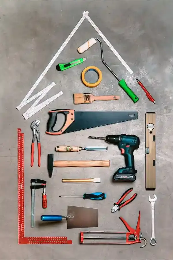 Symbolbild Sanierung – Werkzeuge in Form eines Hauses angeordnet, Hinweis auf Renovierung und energetische Modernisierung in Schweinfurt